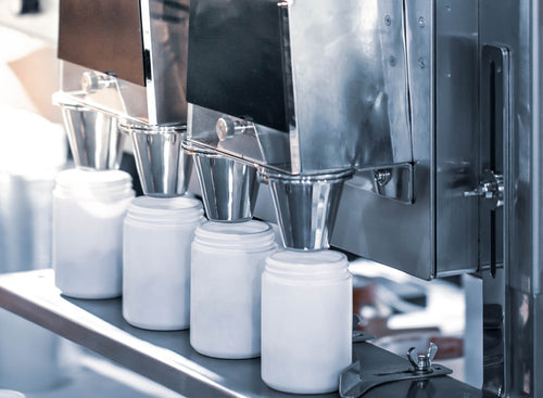 White-label supplement jars being filled on the Propel production line